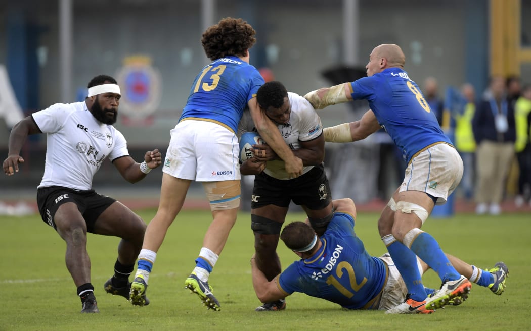 Fiji number 8 Nemani Nagusa is tackled by Italy's Tommaso Castello, Tommaso Boni and Sergio Parisse during their test in Catania.
