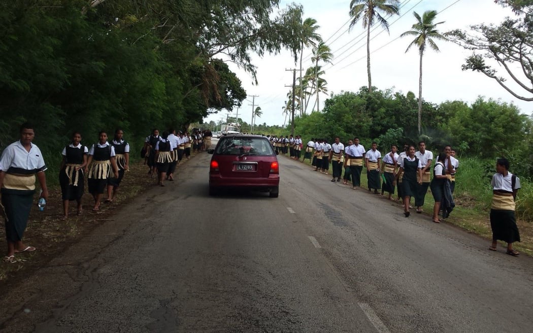 Students prepare to welcome the late Queen Mother Halaevalu Mata'aho