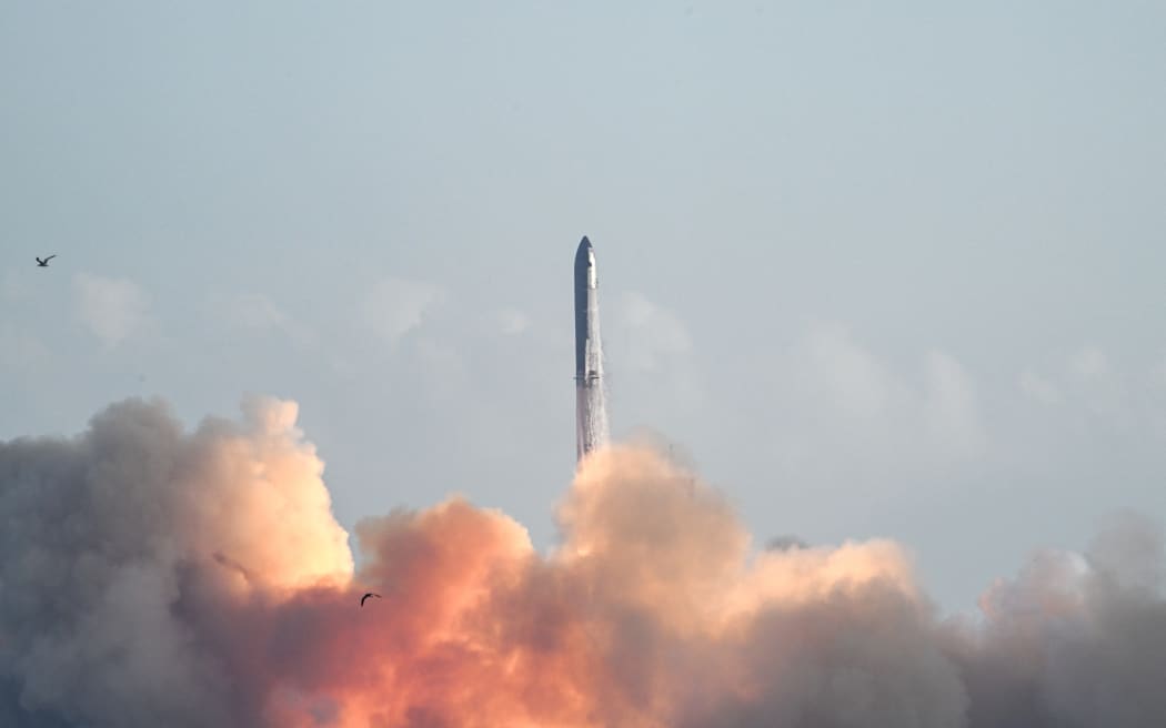 SpaceX's Starship rocket lifts off from Starbase, Texas, as seen from South Padre Island on August 26, 2025, for its tenth test flight. SpaceX's Starship megarocket roared into the skies Tuesday on its 10th test flight, following a string of explosive failures that cast doubt about its ability to realize Elon Musk's vision of colonizing Mars. (Photo by RONALDO SCHEMIDT / AFP)