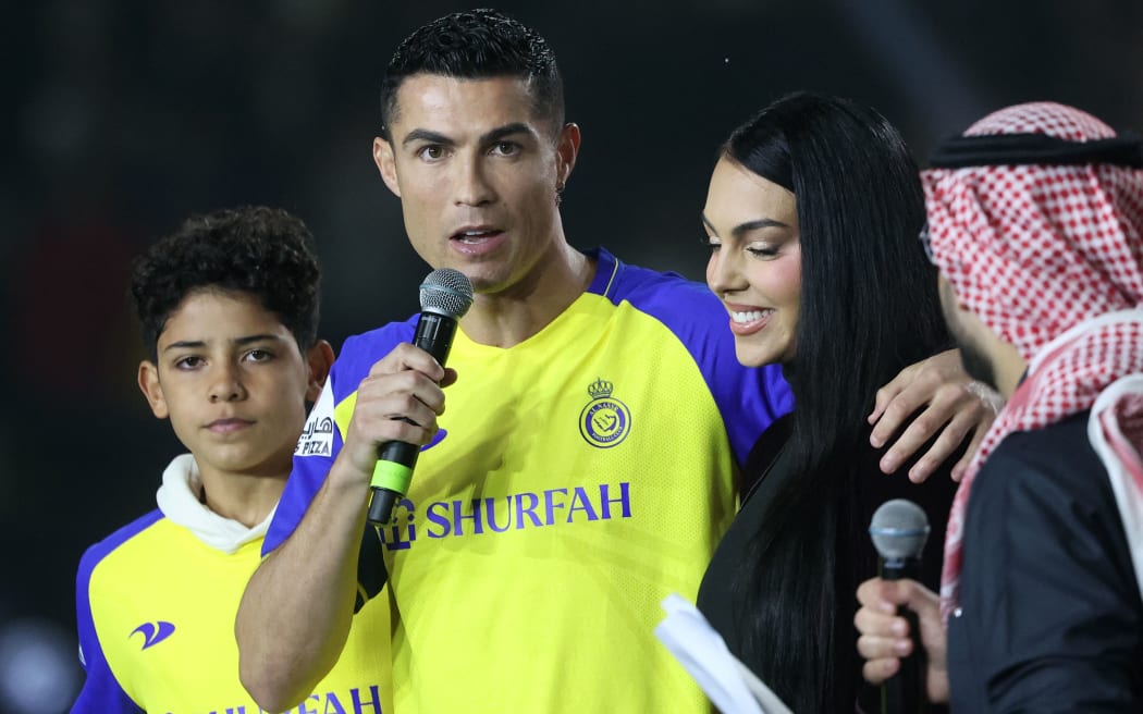 Portuguese forward Cristiano Ronaldo accompanied by his partner Georgina Rodriguez and his son Cristiano Ronaldo Jr, greets the crowd at the Mrsool Park Stadium in the Saudi capital Riyadh on January 3, 2023, upon his presentation as an Al-Nassr player.