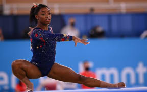 USA's Simone Biles competes in the floor event of the artistic gymnastic women's qualification during the Tokyo 2020 Olympic Games at the Ariake Gymnastics Centre in Tokyo.