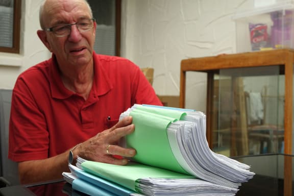 Hugh Johnson with his petition against the Maori wards.