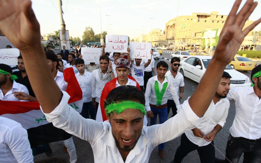 Iraqi men take part in a demonstration to show their support for the call to arms by Shiite cleric Grand Ayatollah Ali al-Sistani.