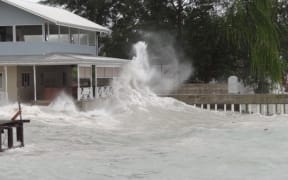 A Majuro business' shoreline bar and store is blasted by high waves kicked up by a tropical depression that was building to typhoon strength Friday night in the Marshall Islands. The waves caused major damage to the capital atoll's three-mile downtown lagoon shoreline.