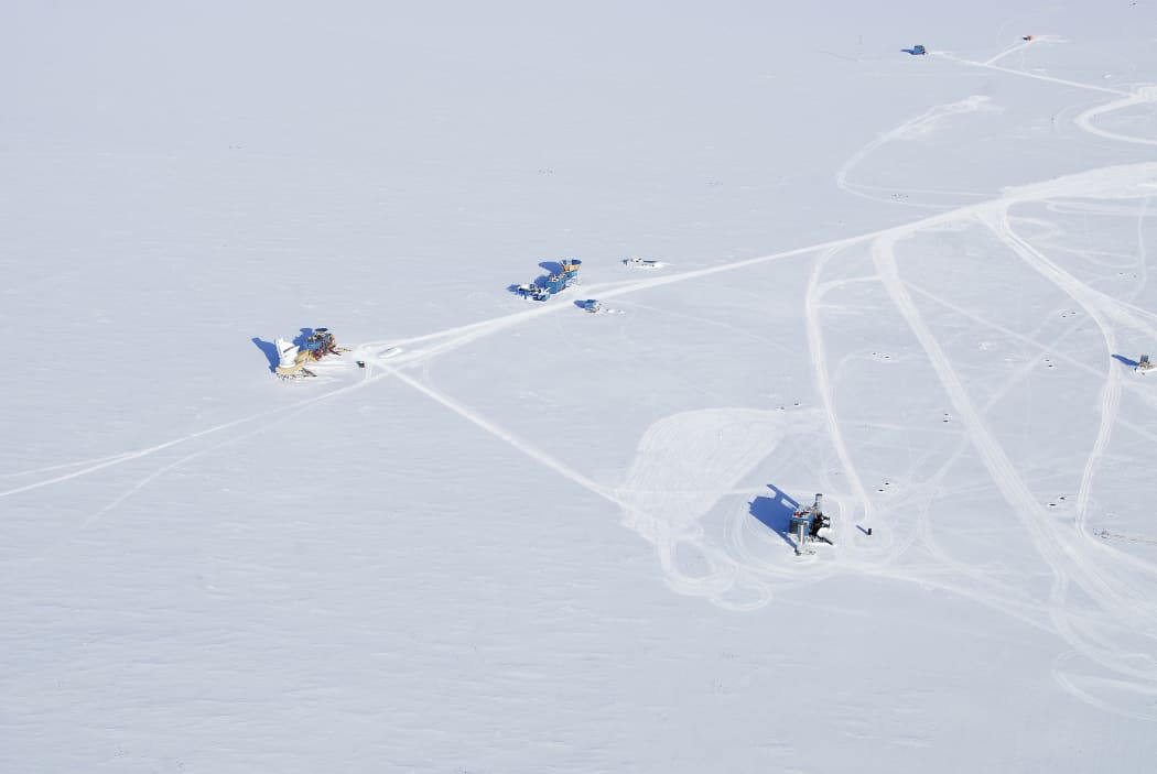 The 'dark sector' at the South Pole is an area without any light and radio wave interference. The blue building in the lower right with two silver towers contains the computer equipment associated with the IceCube neutrino detector.