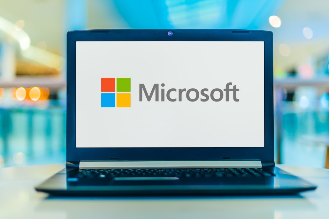 Laptop computer displaying logo of Microsoft, an American multinational technology company with headquarters in Redmond, Washington