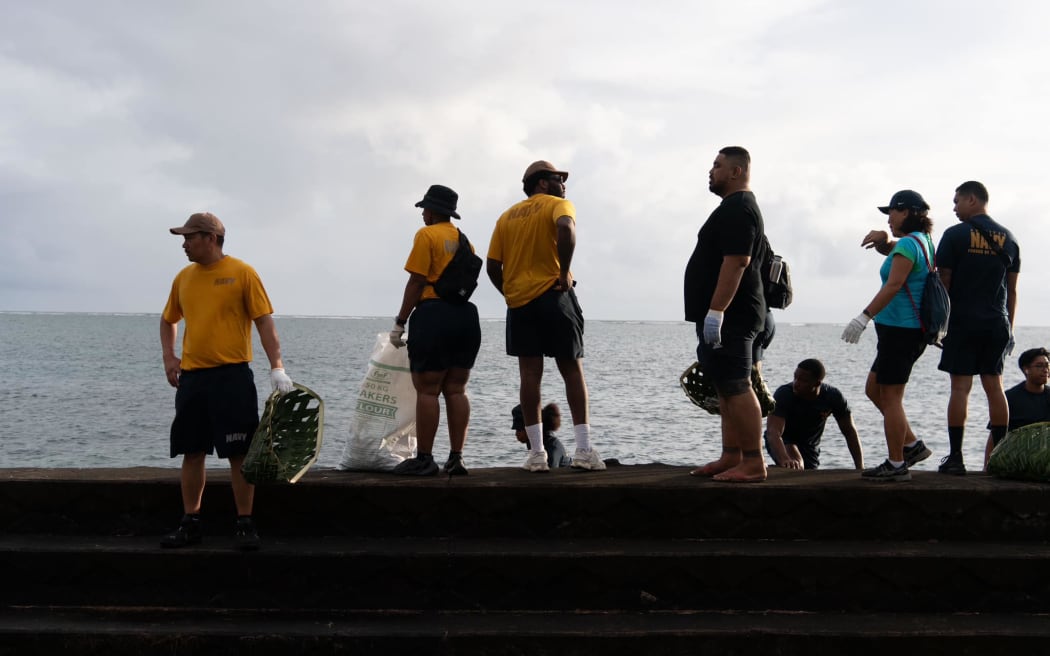 US Navy personnel assist locals in a coastal cleanup effort in Apia.