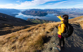 Young person hiking on Roys peak track, Wanaka, South Island, New Zealand