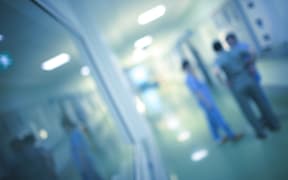 Health care workers in the hospital corridor.