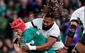 Ireland's Josh van der Flier is tackled by Fiji's Waisea Nayacalevu.