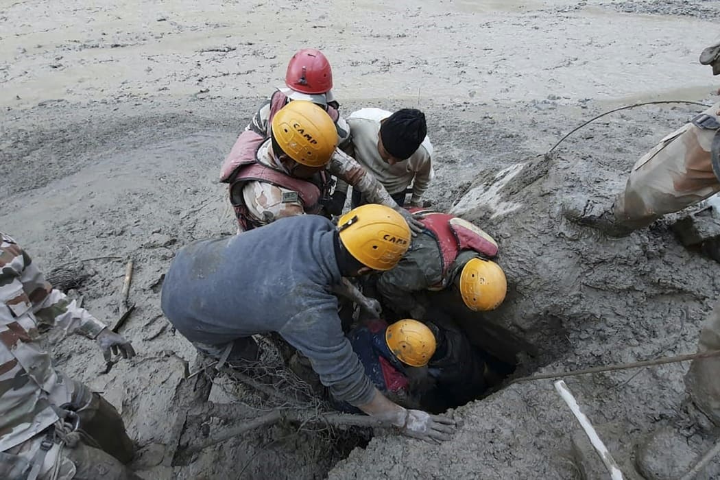 Members of the Indo-Tibetan Border Police during a rescue operation after a broken glacier caused a major river surge that swept away bridges and roads, at Reni village in Chamoli district of Uttarakhand.