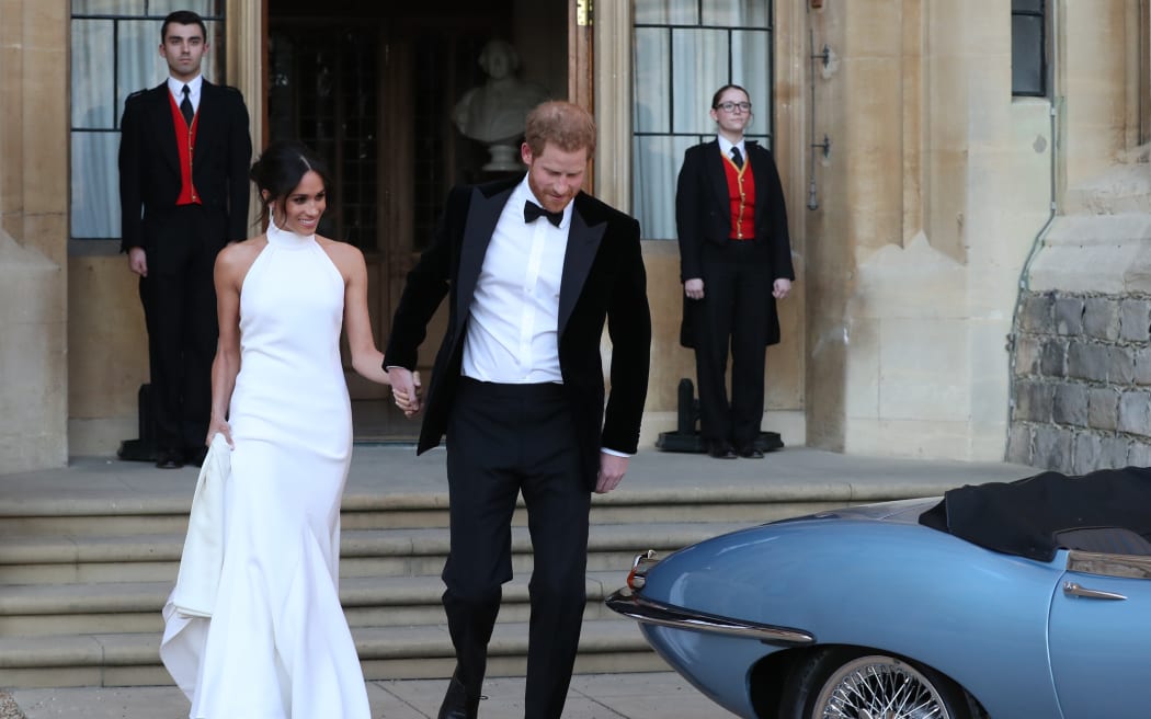 Britain's Prince Harry, Duke of Sussex, (R) and Meghan Markle, Duchess of Sussex, (L) leave Windsor Castle