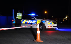 Police at the cordon set up around the house where the bodies were found.