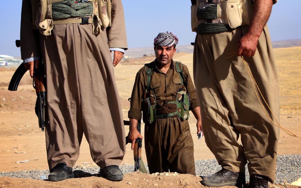Iraqi Kurdish Peshmerga fighters take position on the front line in Khazer, near the Kurdish checkpoint of Aski kalak, 40 km West of Arbil, the capital of the autonomous Kurdish region of northern Iraq.