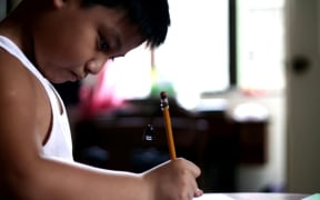 Child writing (file photograph).