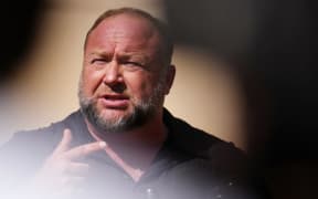 WATERBURY, CONNECTICUT - SEPTEMBER 21: InfoWars founder Alex Jones speaks to the media outside Waterbury Superior Court during his trial on September 21, 2022 in Waterbury, Connecticut. Jones is being sued by several victims' families for causing emotional and psychological harm after they lost their children in the Sandy Hook massacre. A Texas jury last month ordered Jones to pay $49.3 million to the parents of 6-year-old Jesse Lewis, one of 26 students and teachers killed in the shooting in Newtown, Connecticut.   Joe Buglewicz/Getty Images/AFP (Photo by Joe Buglewicz / GETTY IMAGES NORTH AMERICA / Getty Images via AFP)