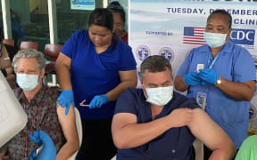 Marshall Islands Health Secretary Jack Niedenthal, left, and Public Health Director Dr Frank Underwood received Covid vaccines in Majuro recently from public health nurses Mineko Mista and Rosabella Jennet.