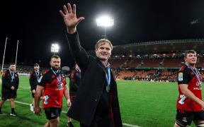 Crusaders head coach Scott Robertson waves to fans and supporters during the victory lap after winning the 2023 Super Rugby Pacific title.