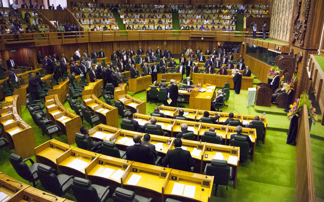 Members of parliament stand to the right of the speaker (R) to approve the vote of Peter O'Neill as prime minister in Port Moresby on August 3, 2012.