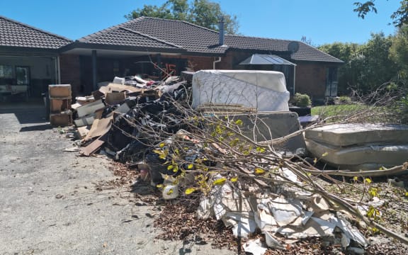 Destroyed items piled outside Peter Mitchell's house in Awatoto, Napier.