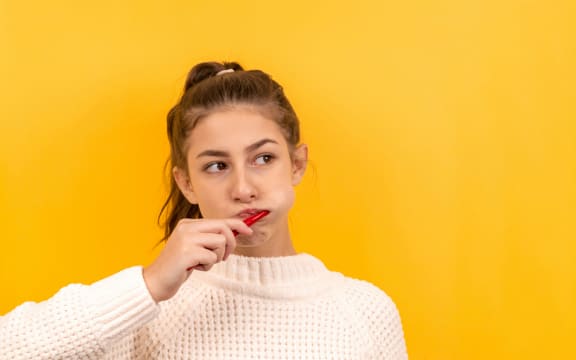 young woman brushing her teeth