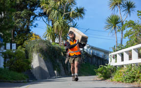 Predator-Free Miramar team member Sebastian du Feu carrying one of the 1800 trap boxes positioned in a 100-metre grid across Miramar Peninsula.