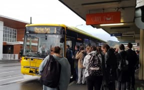 Commuters at a bus stop in Newtown