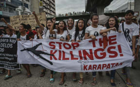Residents and activists chant slogans during the funeral procession of Kian Loyd Delos Santos in Caloocan, Metro Manila, Philippines, August 26, 2017.