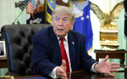 US President Donald Trump talks to reporters after signing an executive order dealing with automobile repairs in the Oval Office at the White House on 29 June, 2026 in Washington, DC.