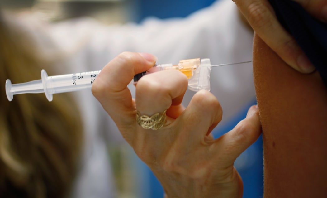 University of Miami pediatrician Judith L. Schaechter gives an HPV vaccination to a 13-year-old girl in her office at the Miller School of Medicine on 21 September 2011 in Miami, Florida.