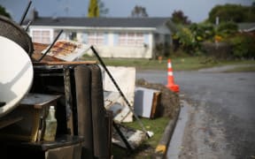Household items are being piled on the curbside.