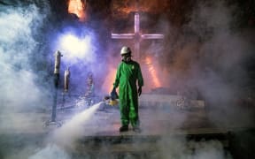 A worker disinfects the Salt Cathedral of Zipaquira, an underground church built into a salt mine, in Colombia on August 30, 2020.