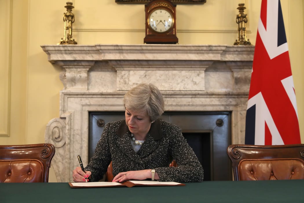 Mrs May signs the six-page Brexit letter on Tuesday 28 March.