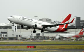 A Qantas plane takes off from the Sydney International airport on May 6, 2021, as Australia's competition regulator said it would block a pricing, code-sharing and scheduling deal between Qantas and Japan Airlines because it would likely mean higher fares for passengers. (Photo by Saeed KHAN / AFP)