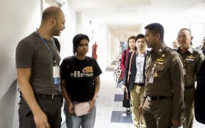 January 7, 2019 shows 18-year-old Saudi woman Rahaf Mohammed al-Qanun (2nd-L) is being escorted by the Thai immigration officer and United Nations High Commissioner for Refugees (UNHCR) officials at the Suvarnabhumi international airport in Bangkok.
