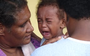 A child in vaccinated for measles in Vanuatu after Cyclone Pam.