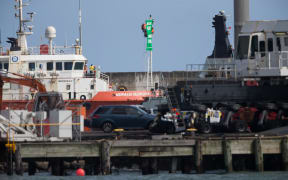 Greenpeace protesters chained to a pole on the tender vessel Mermaid Searcher.