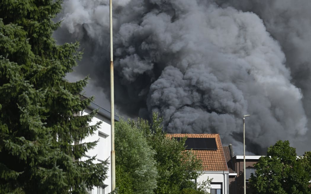 Smoke caused by a fire at the festival site of the Tomorrowland electronic music festival, Wednesday 16 July 2025, in Boom. The first weekend of the festival takes place at the 'De Schorre' terrain in Boom, from 18 to 20 July. BELGA PHOTO TOM GOYVAERTS (Photo by Tom Goyvaerts / BELGA MAG / Belga via AFP)