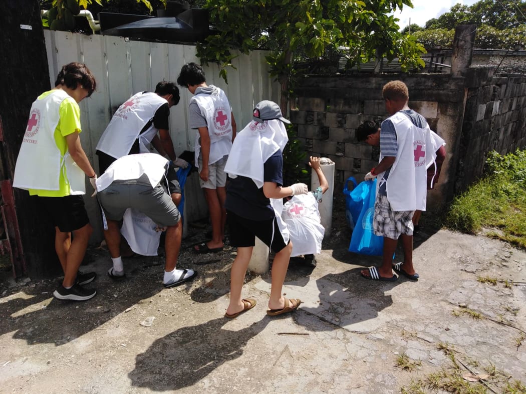 Red Cross volunteers cleaning up mosquito breeding sites in Majuro