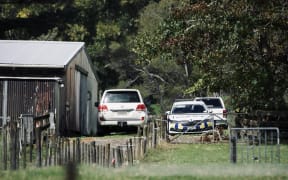 Police cars at a property on Anzac Valley Rd in rural Waitākere, west Auckland, on 18 April 2024.