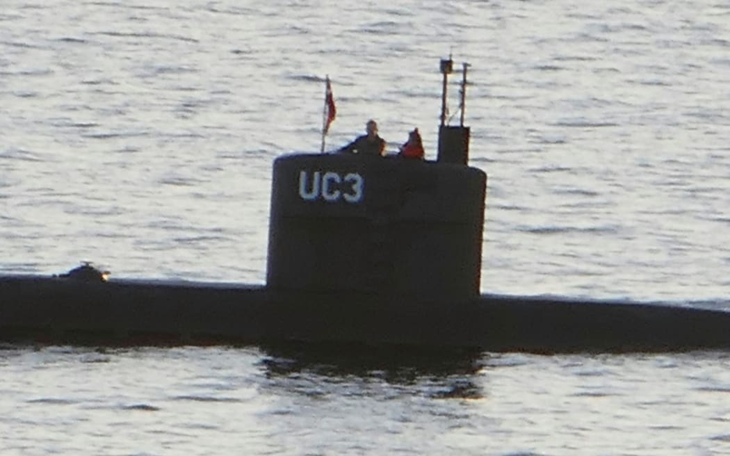 An image from Danish media allegedly showing Kim Wall standing next to Peter Madsen on his submarine.
