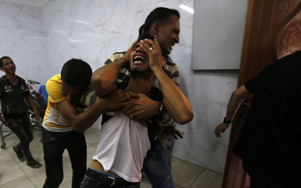 A relative of the two Palestinian men, who were killed in an Israeli air strike the night before, mourns in the morgue upon identifying the bodies in Khan Yunis in the southern Gaza Strip on September 18, 2018.