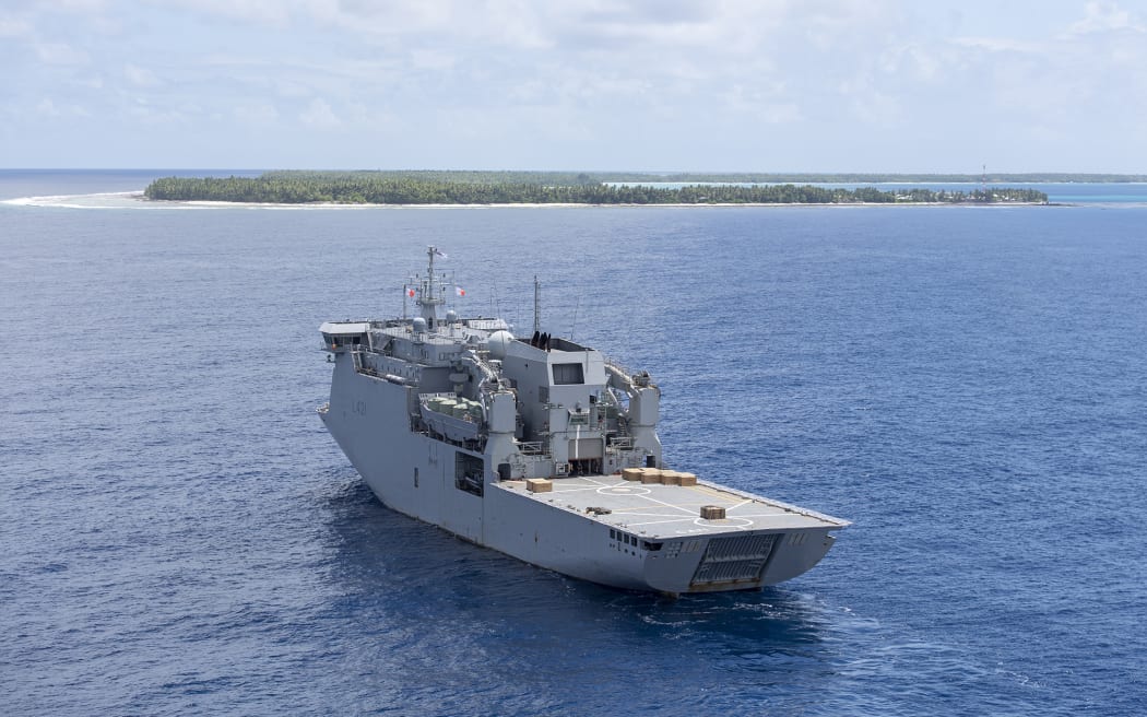 HMNZS Canterbury, pictured with Atafu atoll in the background.