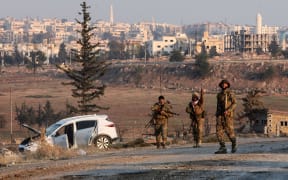 Anti regime fighters hold a position in New Aleppo on the outskirts of the northern Syrian city of Aleppo on November 29, 2024. - Jihadists and their Turkish-backed allies took control of five districts of Syria's second city of Aleppo on November 29, "without any significant pushback" from the Syrian military, a war monitor said. (Photo by Bakr ALKASEM / AFP)