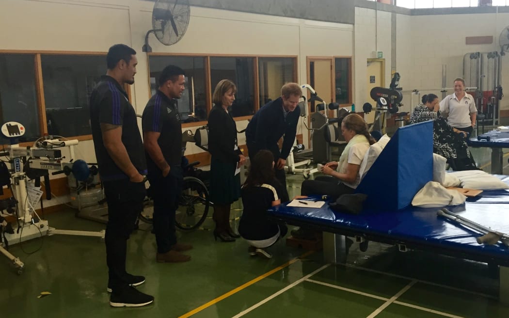 Kevin Mealamu and Jerome Kaino join Prince Harry to meet with current patients.