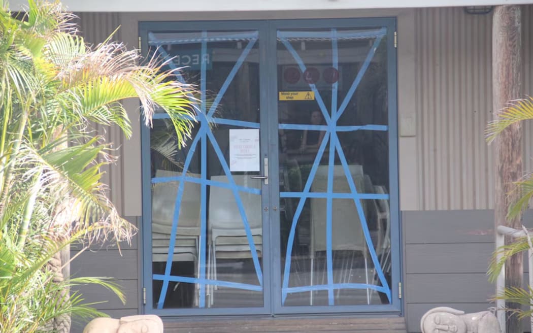 Glass doors taped up in Exmouth in preparation for Tropical Cyclone Mitchell.  (ABC News: Macey Turner)