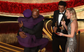 Best Adapted Screenplay winner for "BlacKkKlansman" Spike Lee (L) jumps in the arms of Actor Samuel L. Jackson as he accepts the award.