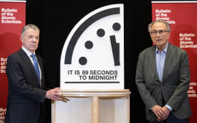 Former President of Colombia Juan Manuel Santos (L), chair of the Elders, and Robert Socolow (R), professor emeritus at Princeton University and member of the Atomic Scientists' Science and Security Board, unveil the Doomsday Clock at 89 seconds to midnight, the closest the clock has ever been to midnight in its 78-year history to signal that the world is on a course of unprecedented risk, as set by the Bulletin of the Atomic Scientists' Science and Security Board, at the US Institute of Peace in Washington, DC, January 28, 2025. According to the Bulletin of Atomic Scientists, the Doomsday Clock, created in 1947, is a metaphorical design that warns the public about how close we are to destroying our world with dangerous technologies of our own making.