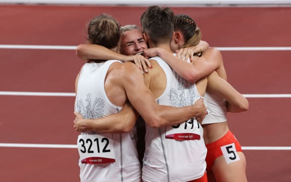 (FromL)  Poland's Karol Zalewski, Poland's Justyna Swiety-Ersetic, Poland's Kajetan Duszynski and Poland's Natalia Kacmarek celebrate after winning the mixed 4x400m relay final during the Tokyo 2020 Olympic Games at the Olympic Stadium in Tokyo on July 31, 2021.