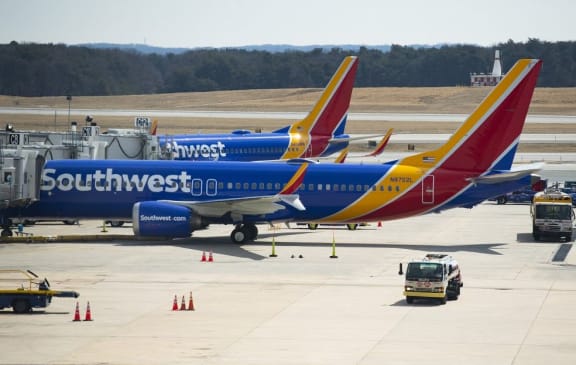 (FILES) In this file photo taken on March 13, 2019 a Boeing 737 Max 8 flown by Southwest Airlines sits at the gate at Baltimore Washington International Airport  near Baltimore, Maryland.